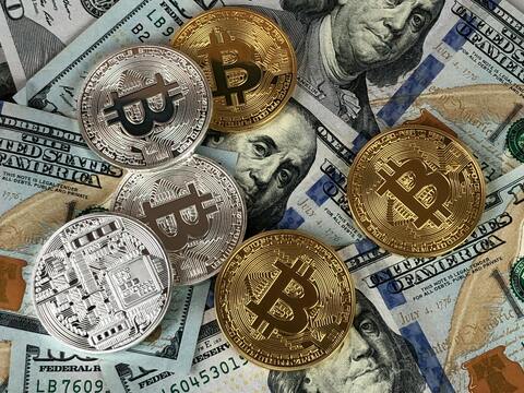 Bitcoin coins on dollar bills — Crypto Licensing News 2026 — Approvals, Enforcement & Up