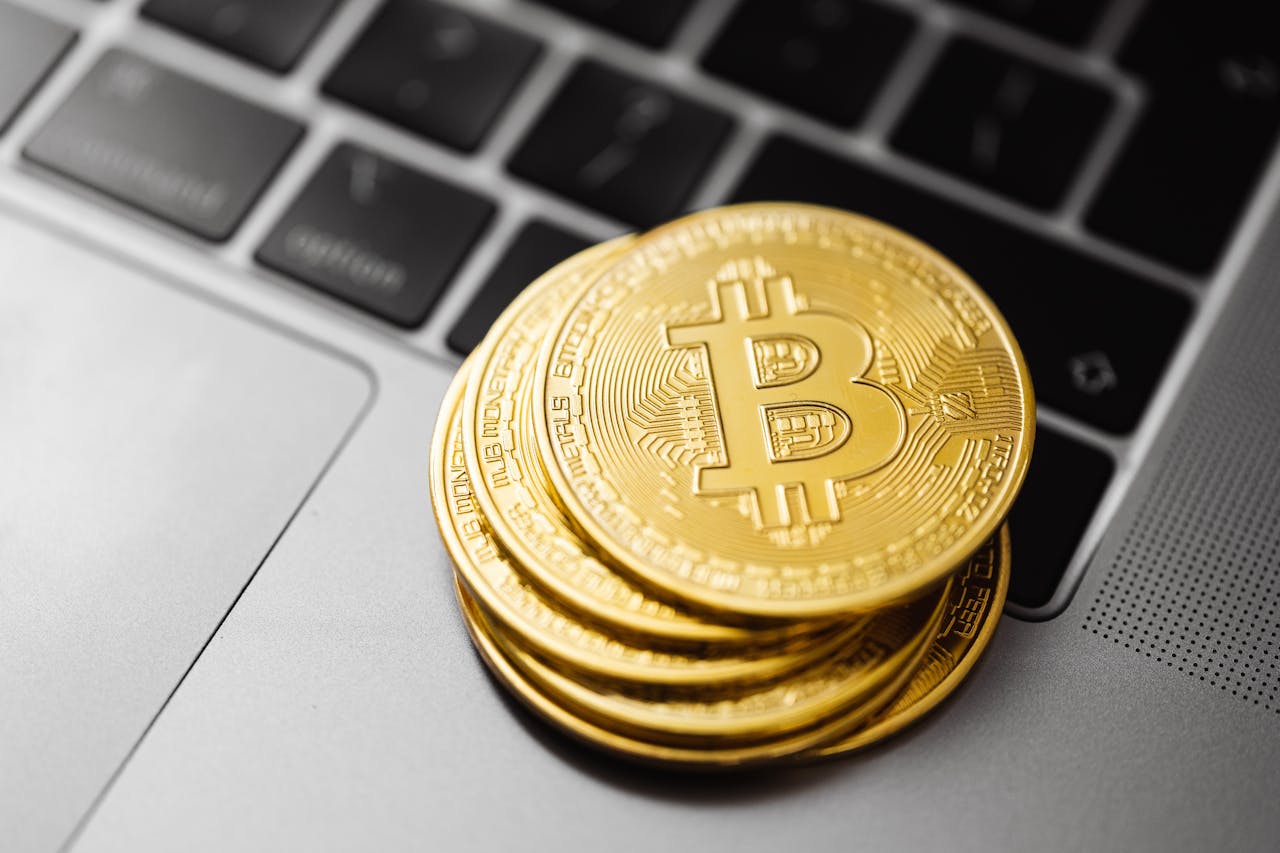 Bitcoin stack coins laptop keyboard — Dr. Marcus Hartmann