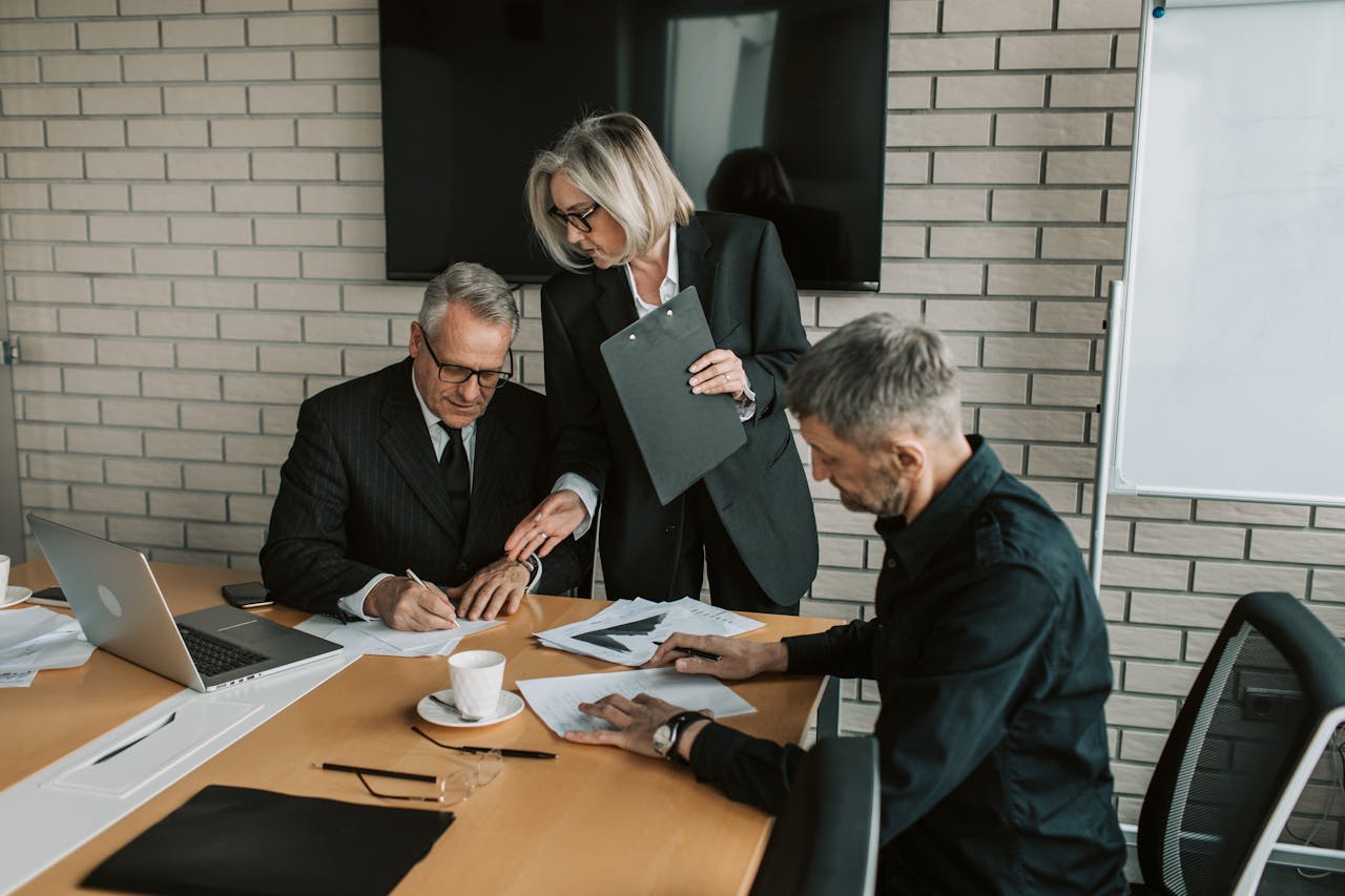 Business meeting signing documents team — Crypto License