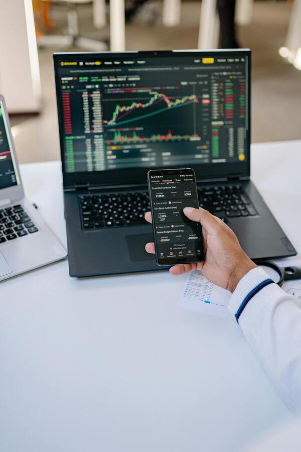 Trader phone laptop stock charts — Africa Crypto Licenses — The Continent's VASP Landscape 2026